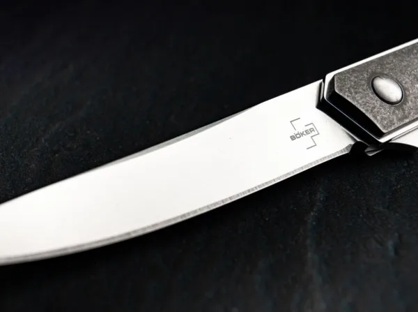 Nóż Böker Plus Kwaiken Air Titanium Boker Plus Kwaiken Air Titan od Lucasa Burnleya rozszerza dynastię odnoszącej sukcesy rodziny Kwaiken o elegancką lekką wersję. Dzięki prostemu i praktycznemu kształtowi ten nowoczesny scyzoryk stał się prawdziwą ikoną. Czyste linie i smukła konstrukcja tego modelu zostały dodatkowo zoptymalizowane, aby osiągnąć bezkompromisową redukcję wagi, chociaż nóż nadal trzyma całe ostrze, gdy jest zamknięty. Flipper zapewnia intuicyjną obsługę i dodatkowe bezpieczeństwo, a linerlock bezpiecznie blokuje ostrze łożyska kulkowego VG-10 z satynowym wykończeniem Hairline. Lekkość Gentleman Folder podkreślają wysokiej jakości tytanowe łuski rękojeści, które nadają nożowi niezwykle nowoczesny wygląd. Z otworem na smycz, odczepianym, głębokim klipsem do przenoszenia (w górę/w górę) i wysokiej jakości nylonowym etui do przechowywania.