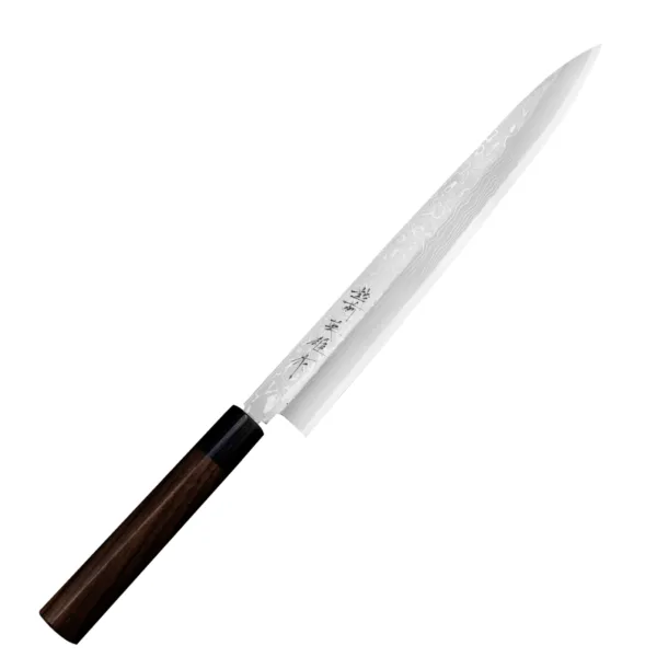 Hideo Kitaoka Nóż Shirogami Satin Yanagi 27 cm Hideo Kitaoka Nóż Shirogami Satin Yanagi 27 cm
Klasyczny japoński nóż kuchenny do plastrowania o długim, wąskim i cienkim ostrzu w kształcie liścia wierzby, przeznaczony do cięcia surowych filetów rybnych na cieniutkie, niemal przezroczyste plastry. Doskonale się sprawdza podczas przygotowywania sashimi, rybnego carpaccio oraz różnych wariantów sushi. Nożem Yanagi najlepiej wykonywać jednostajny ruch w jednym kierunku: do siebie. W tym modelu krawędź grzbietu ma szlif ukośny, co zwiększa wygodę przy prowadzeniu noża palcem wskazującym.
Dane techniczne:
Ostrze - stal 11 warstwowa rdzewna stal, rdzeń - #2 ShirogamiRękojeść - drewno różaneTwardość - 61-63 HRCDługość całkowita - 41,5 cmDługość ostrza - 27 cmSzerokość klingi - 3,3 cmGrubość klingi - 3,8 mmSposób ostrzenia - jednostronnyWaga - ok. 172 g